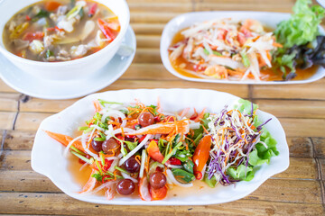 spicy salad serve with grape and crab sticks