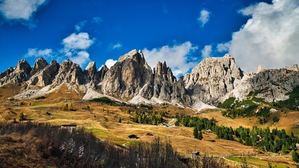 Obraz premium Dolomites Mountains in autumn season. Bright blue sky with a few clouds. Italy