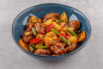 Chicken with pineapple in teriyaki sauce on a stone background studio shooting 7