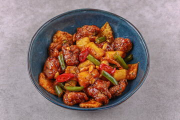 Chicken with pineapple in teriyaki sauce on a stone background studio shooting 4
