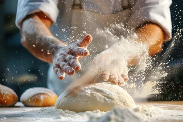 Gordijnen A baker kneads dough preparing it for baking fresh bread against blurred bakery background. © julijadmi