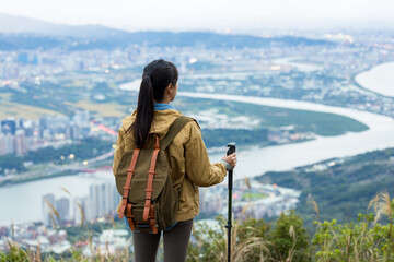 Woman go hiking and look at the Taipei city