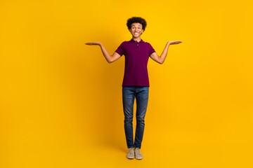 Photo of attractive man in trendy magenta clothes presenting two quality novelty products empty...