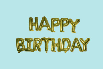 Golden balloon text of Happy Birthday on the blue background. Concept of celebration. Gold foil helium balloons.