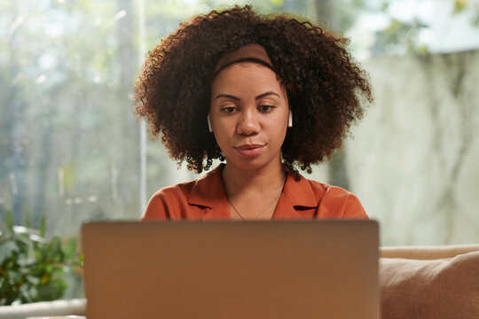 Portrait Of Woman Watching Educational Video On Laptop At Home