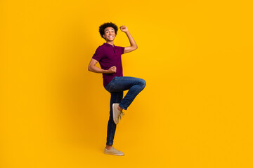 Fototapeta na wymiar Photo of funky cheerful glad guy wear violet stylish clothes raised hands yes win lottery jackpot isolated on yellow color background