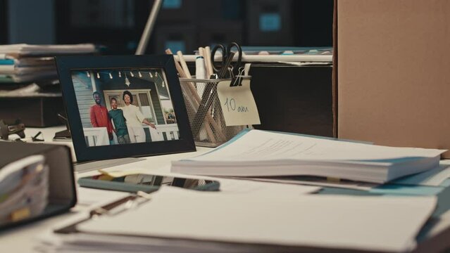 No people shot of happy African American family portrait in picture frame on white office desk at workplace