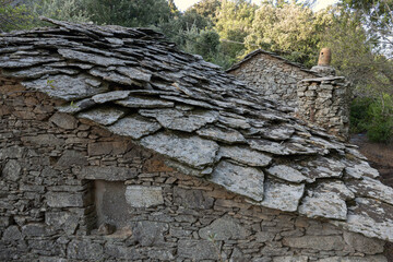 Traditional Ikarian old stone house with slate shingles in the quaint mountain village Vrakades, Ikaria, North Aegean islands, Greece