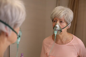 Senior woman using a breathing aid