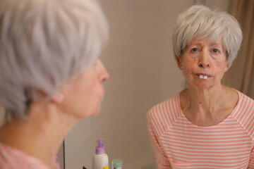 Senior woman playing with bunny teeth 