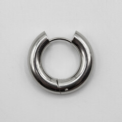 Fake hard earring. White silver ear ring. Imitation jewelry. Accessory for rockers, rap, hip-hop,...