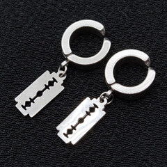 Fake hard earring with blade. White silver ear ring. Imitation jewelry. Accessory for rockers, rap,...
