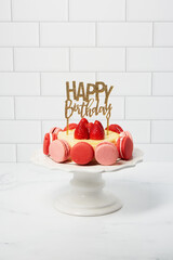 Birthday French Macarons Cheesecake with fresh strawberries on white marble and subway tile