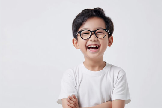 Cheerful kid wearing eyeglasses having fun on white studio background. Copy space