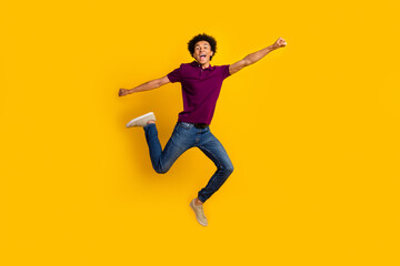 Fototapeta na wymiar Full length photo of glad optimistic man wear trendy polo raise fist going fast crazy adventure isolated on yellow color background