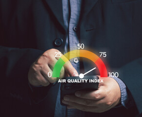 Businessman pointing at virtual screen measuring. concept of pm2.5 indicator weather air on mobile phone. air pollution and dust. health care, environment. Air Quality index.