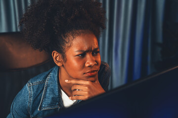 Young African American creator woman with serious face, thinking carefully and looking at final...