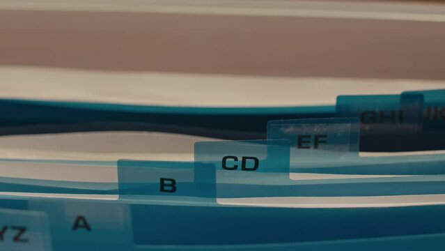 No people closeup of documents folders in file box organizer with index cards sorted in alphabetical order