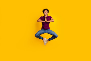 Fototapeta na wymiar Full length photo of concentrated focused guy wear stylish violet polo meditate pray two hands touch isolated on yellow color background