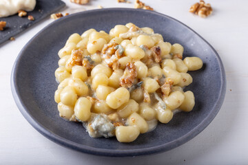 Gnocchi with Gorgonzola and walnuts. Typical Italian food.