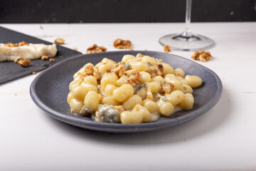 Gnocchi with Gorgonzola and walnuts. Typical Italian food.