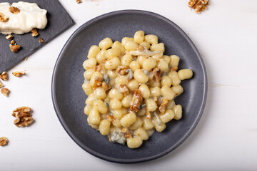 Gnocchi with Gorgonzola and walnuts. Typical Italian food.