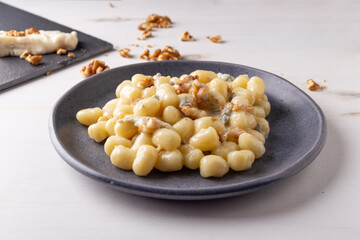 Gnocchi with Gorgonzola and walnuts. Typical Italian food.