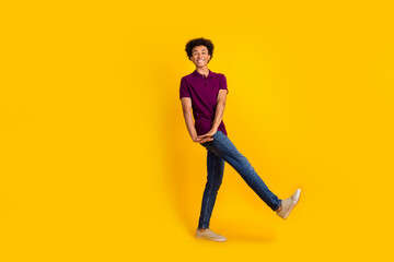 Fototapeta na wymiar Full length photo of glad attractive man wear trendy purple clothes rejoice celebrate holiday festival isolated on yellow color background