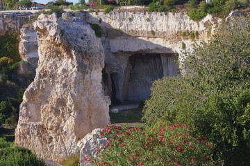 Quarry, limestone cave in archaeological park. Syracuse, Sicily, Italy