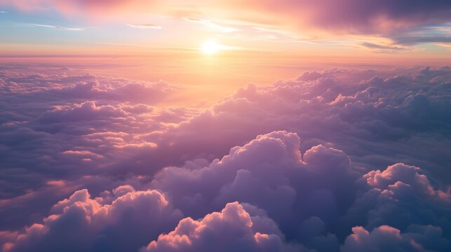 Pink and orange clouds flying above the clouds at sunset or sunrise