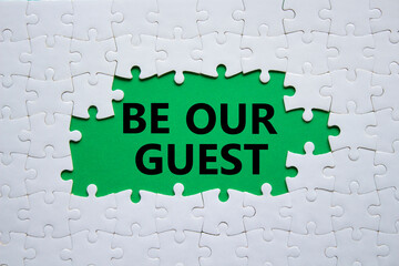 Be our guest symbol. Concept words Be our guest on white puzzle. Beautiful green background. Business and Be our guest concept. Copy space