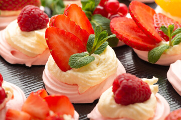 fruit meringue cake Pavlova with fresh berries and mint