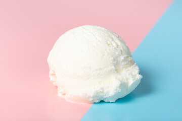 vanilla scoop of sundae ice cream on blue and pink background, close up