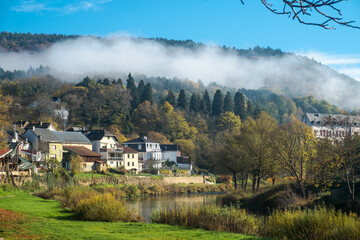 Autumn landscape with forest and the river Sauer at the village of Bollendorf, Germany 