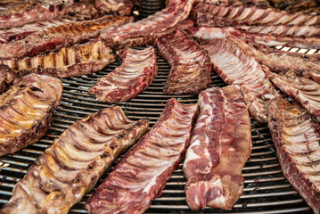 Close-up of raw pork ribs on barbecue grill. Food background