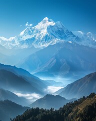 Panoramic view of a majestic mountain range with snow-capped peaks under a clear blue sky