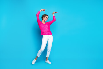 Fototapeta na wymiar Full length photo of cheerful pretty woman wear knitted neon shirt having disco fun empty space isolated blue color background