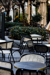 Empty chairs in coffee bar, outdoor seating but empty due to economic crisis and cold winter weather, on the streets of urban metropolis