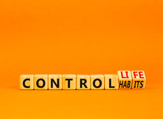 Control habits and life symbol. Concept words Control habits to Control life on beautiful wooden cubes. Beautiful orange table orange background, copy space. Business control habits and life concept.