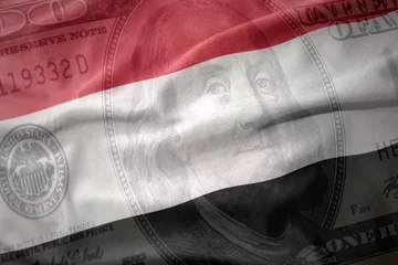 Foto op Plexiglas waving national flag of yemen on a american dollar money background. finance concept. © luzitanija