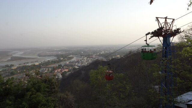 Haridwar, Uttarakhand, India - 10.04.2021 : Rope-way service or Mansa Devi Udankhatola. Mansa Devi Temple, dedicated to goddess Mansa Devi , atop the Bilwa Parvat on the Sivalik Hills, Himalayas.