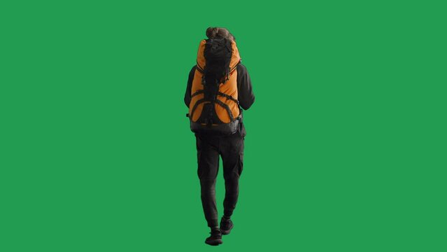 Back view of a full length male hiker with a large hiking backpack on his back. Man walking on green screen. Hiking trek rest travel trip concept.