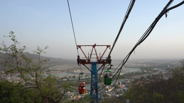 Haridwar, Uttarakhand, India - 10.04.2021 : Rope-way service or Mansa Devi Udankhatola. Mansa Devi Temple, dedicated to goddess Mansa Devi , atop the Bilwa Parvat on the Sivalik Hills, Himalayas.