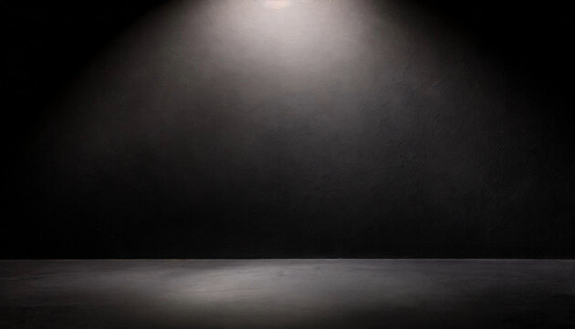 An empty black room illuminated by a spotlight, ideal for text mockup or product presentation.
