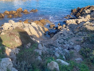 Fototapeta na wymiar Mediterranean Coastline with Rocks and Blue Sky