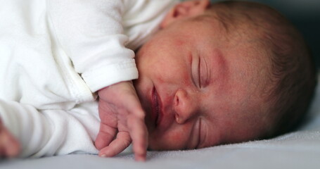 Baby newborn waking up after nap opening eyes and observing the world