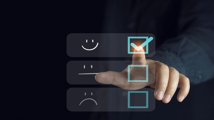 Customer service and Satisfaction concept, Business people touching the virtual screen on the happy Smile face icon to give satisfaction in service. rating very impressed.