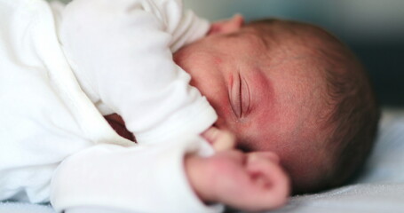 Baby newborn waking up from nap stretching body