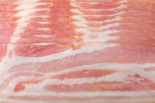 Raw bacon cut into thin slices