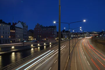 Deurstickers a view of a city street filled with traffic at night © niklas storm
